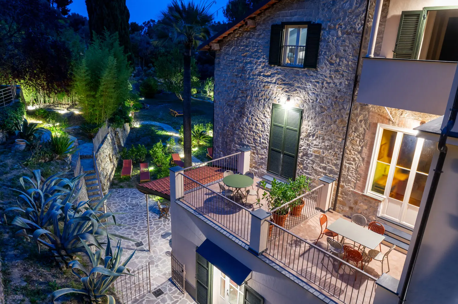 Villa Rappis terrace lit up among the plants